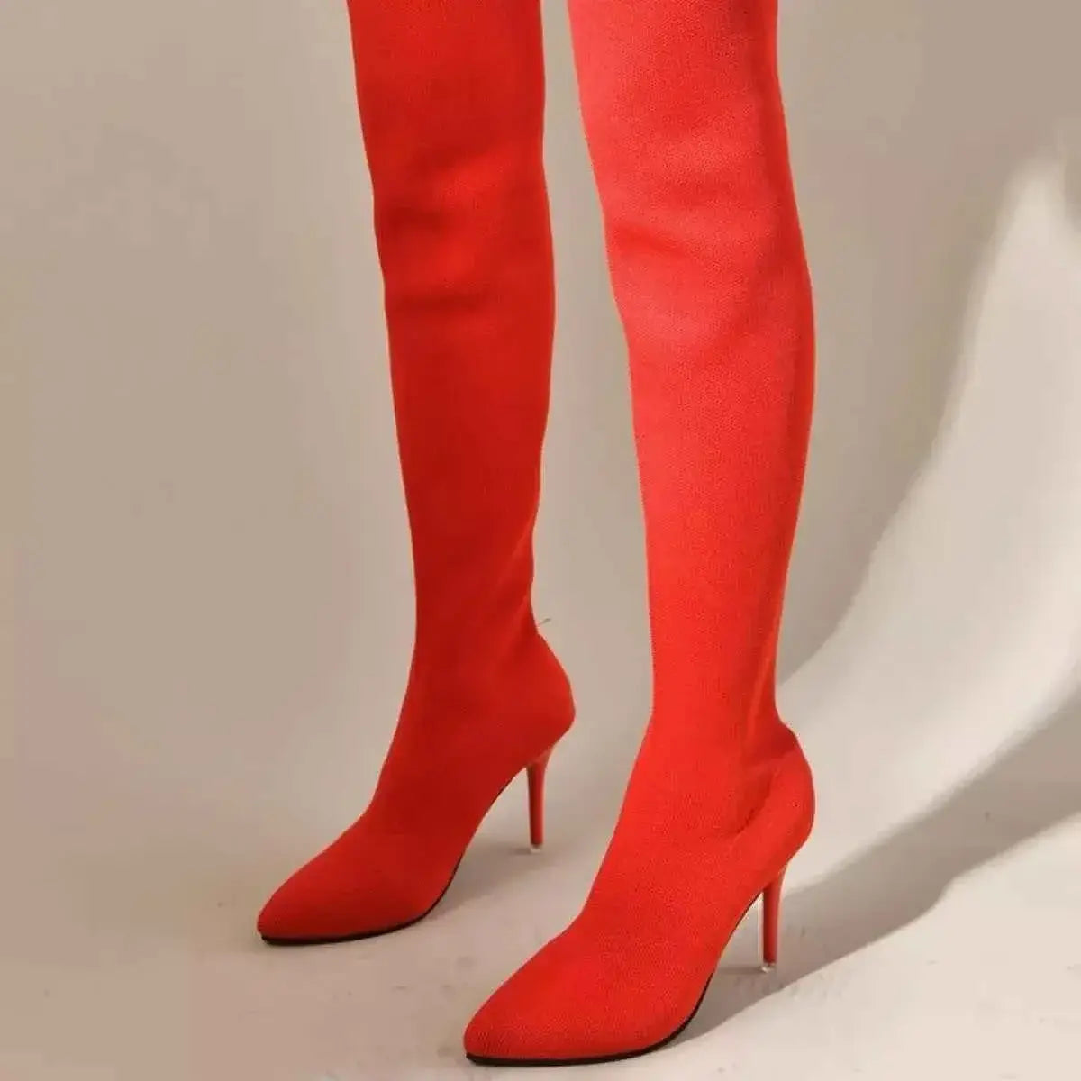 Point Toe Stiletto Boots in bright red fabric with a pointed toe and high, slim stiletto heel extending above the knee.