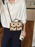 Polka Dot Crossbody Bag in beige polyester with black polka dots and brown trim worn with a white shirt and black pants