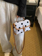 Polka Dot Crossbody Bag in white polyester with black polka dots and brown trim, small size with flap closure