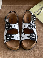 Polka Dot Double Buckle platform sandals in white with black polka dots, two black buckles, and a cork sole