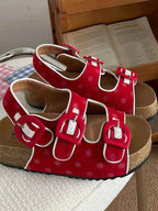 Polka Dot Double Buckle red platform sandals with white polka dots, large red buckles, and cork sole flats