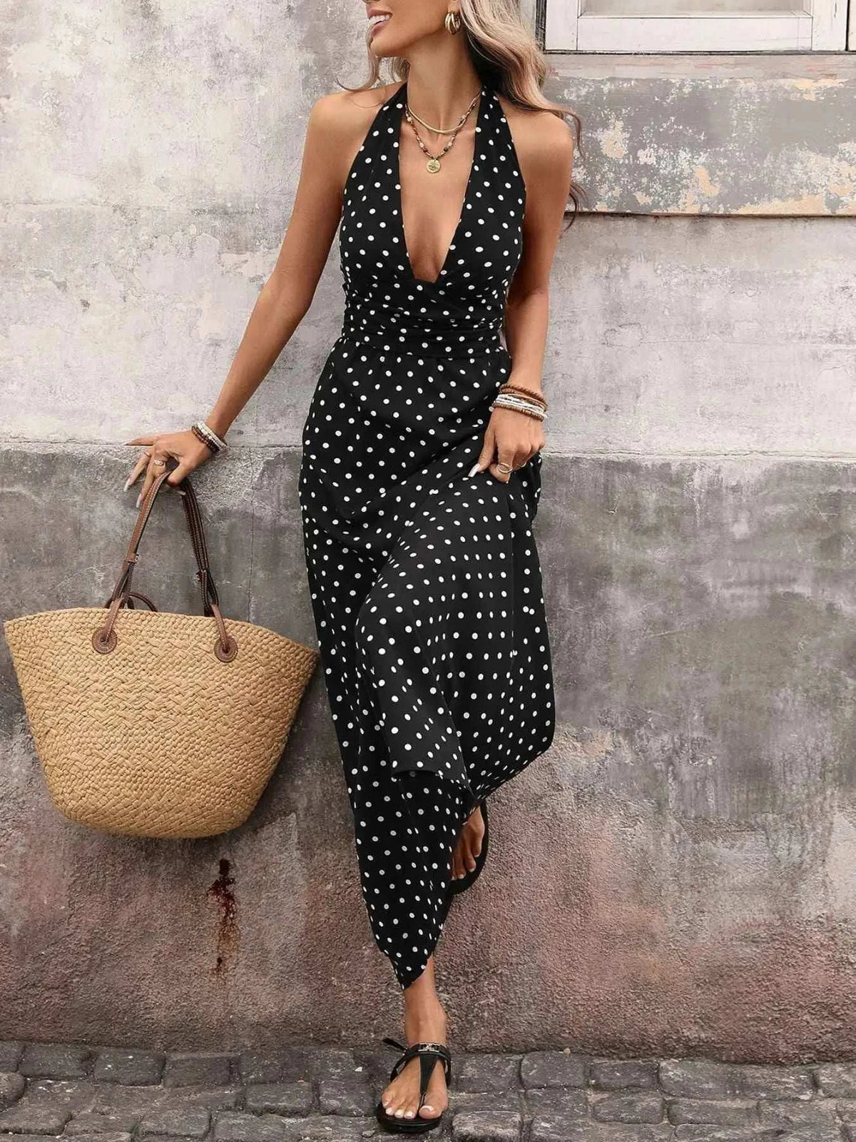 Polka Dot Halter Neck Maxi Dress in black with white polka dots featuring tied halter neck and flowy skirt design