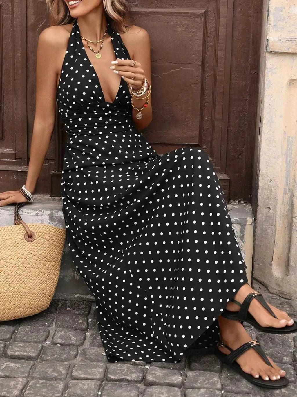 Polka Dot Halter Neck Maxi Dress in black with white polka dots, sleeveless halter style with a deep V neckline and tied neck closure