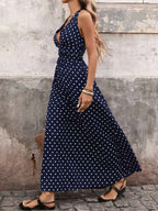 Polka Dot Halter Neck Maxi Dress in navy with white polka dots, sleeveless tied halter neck and flowing skirt