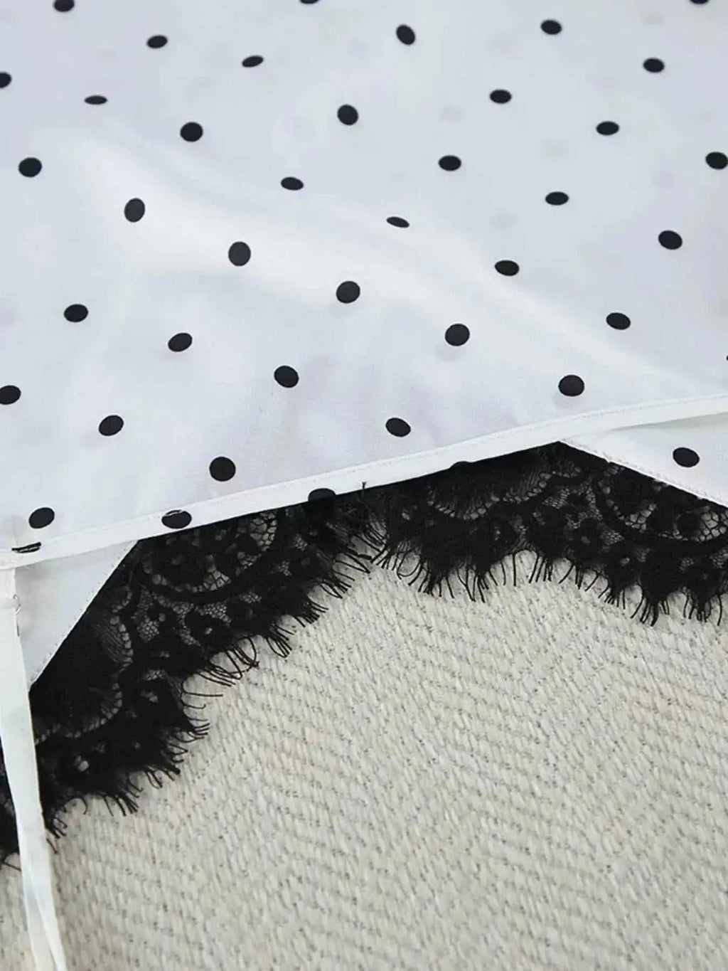 Polka Dot Lace Trim white fabric with black polka dots and delicate black lace trim detail