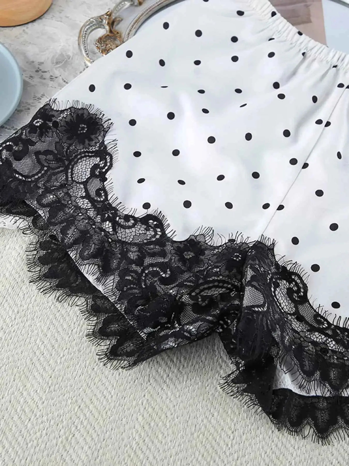 Polka Dot Lace Trim white fabric shorts with black polka dots and detailed black lace trim edges, slightly stretchy polyester