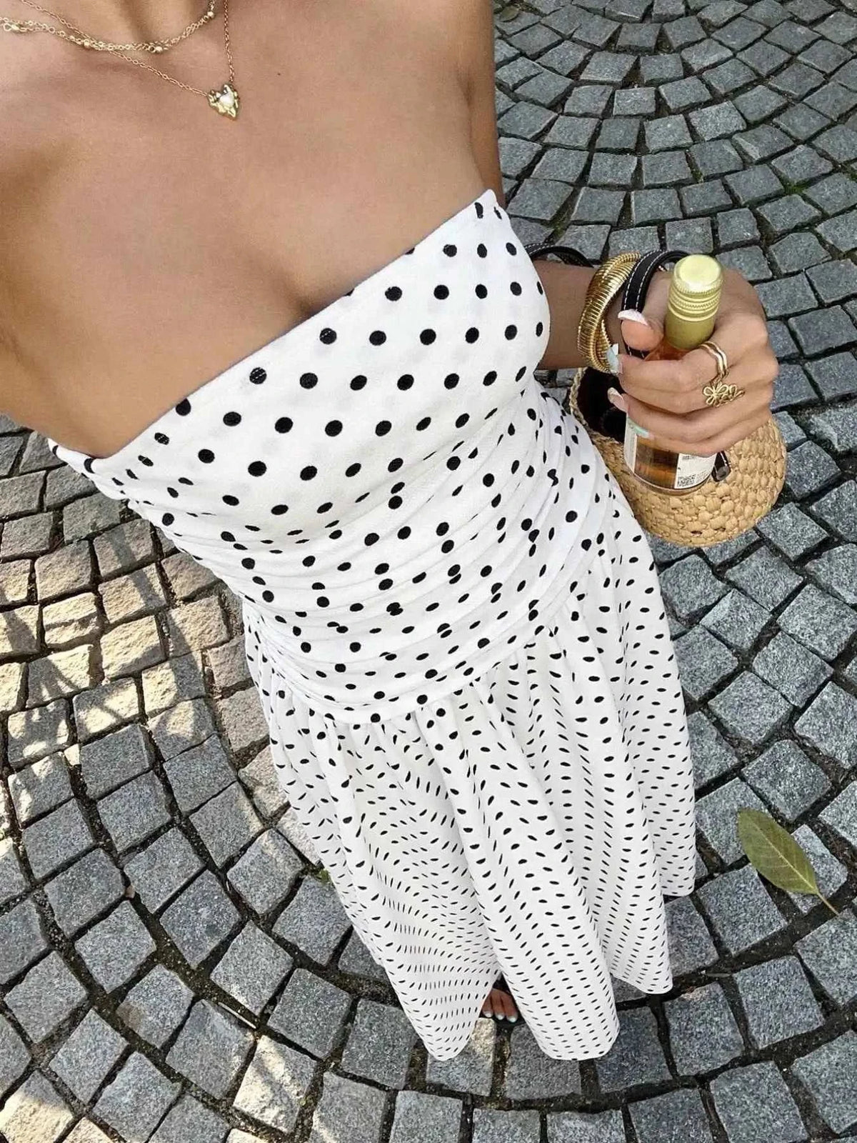 Polka Dot Ruched strapless maxi dress in white with black polka dots, featuring a fitted ruched bodice and flowy skirt