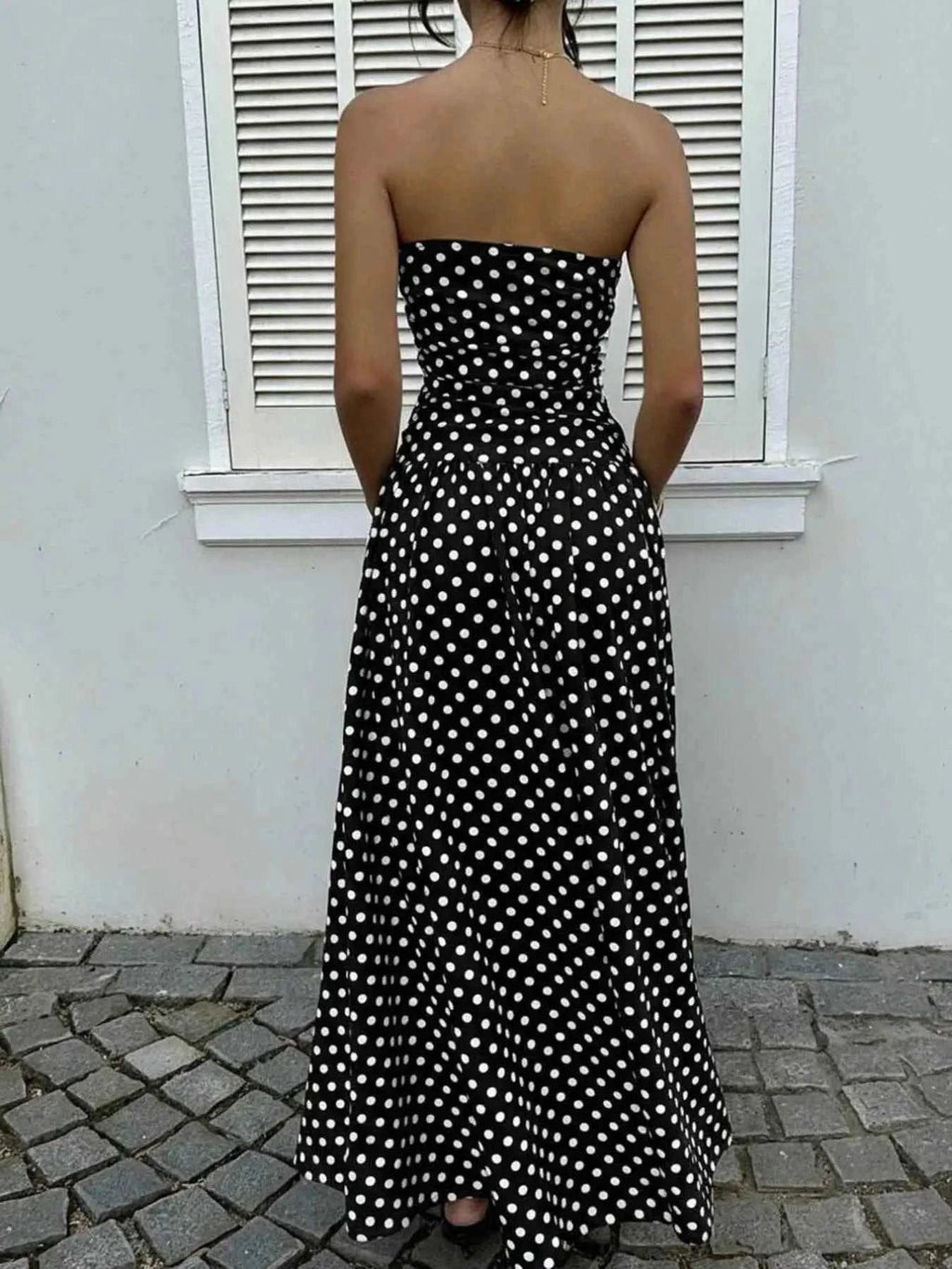 Polka Dot Ruched strapless maxi dress in black with white polka dots and a fitted ruched bodice