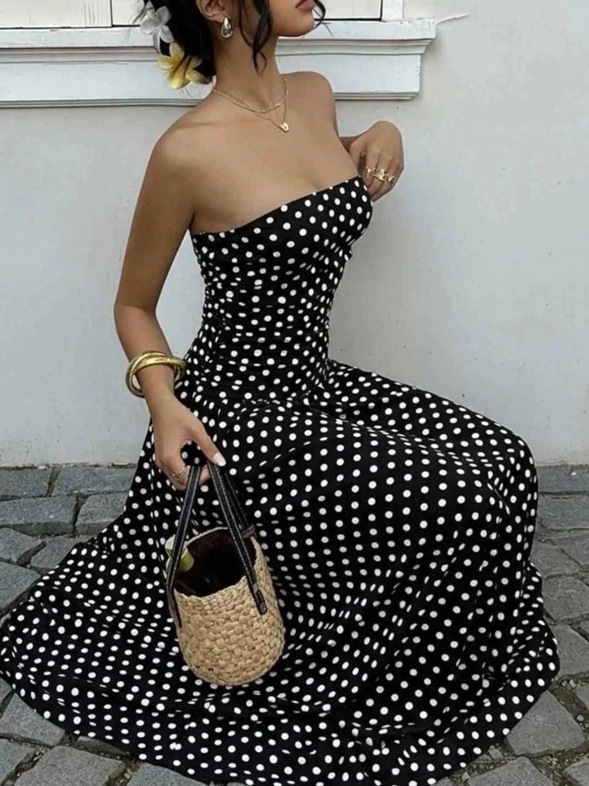 Polka Dot Ruched strapless maxi dress in black with white polka dots, fitted ruched bodice, flowing skirt, sleeveless