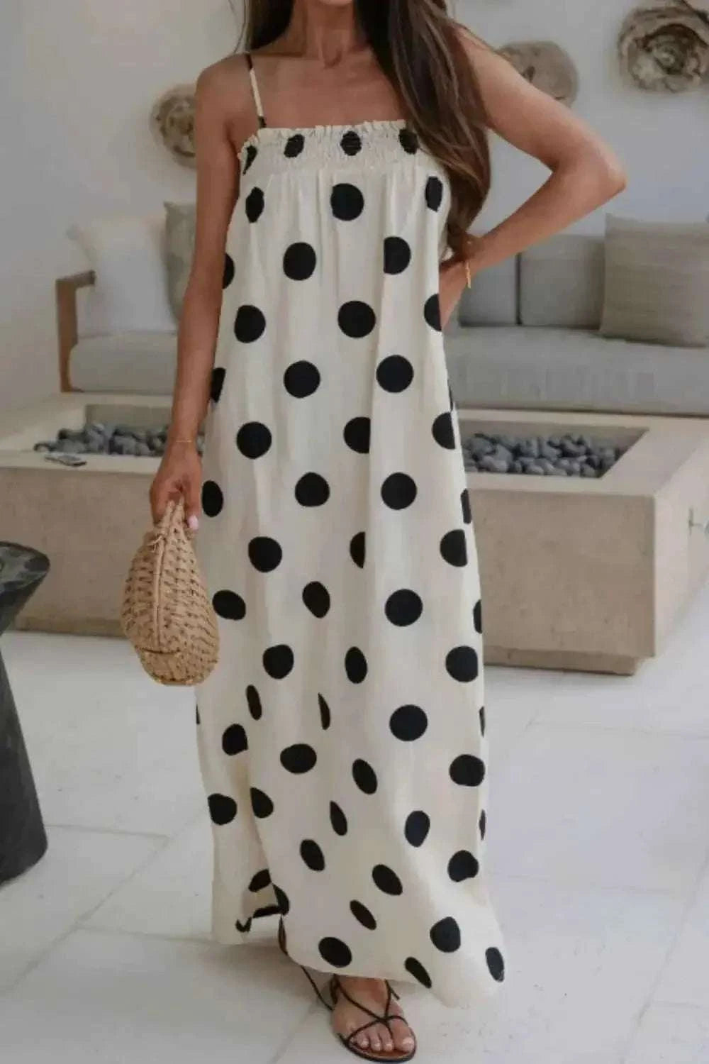 Polka Dot Spaghetti Straps Maxi Dress in white with large black polka dots, smocked bodice, and pocketed sides, sleeveless
