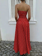 Polka Dot Strapless Maxi Dress in red with white polka dots, fitted bodice, and flowing skirt from the back
