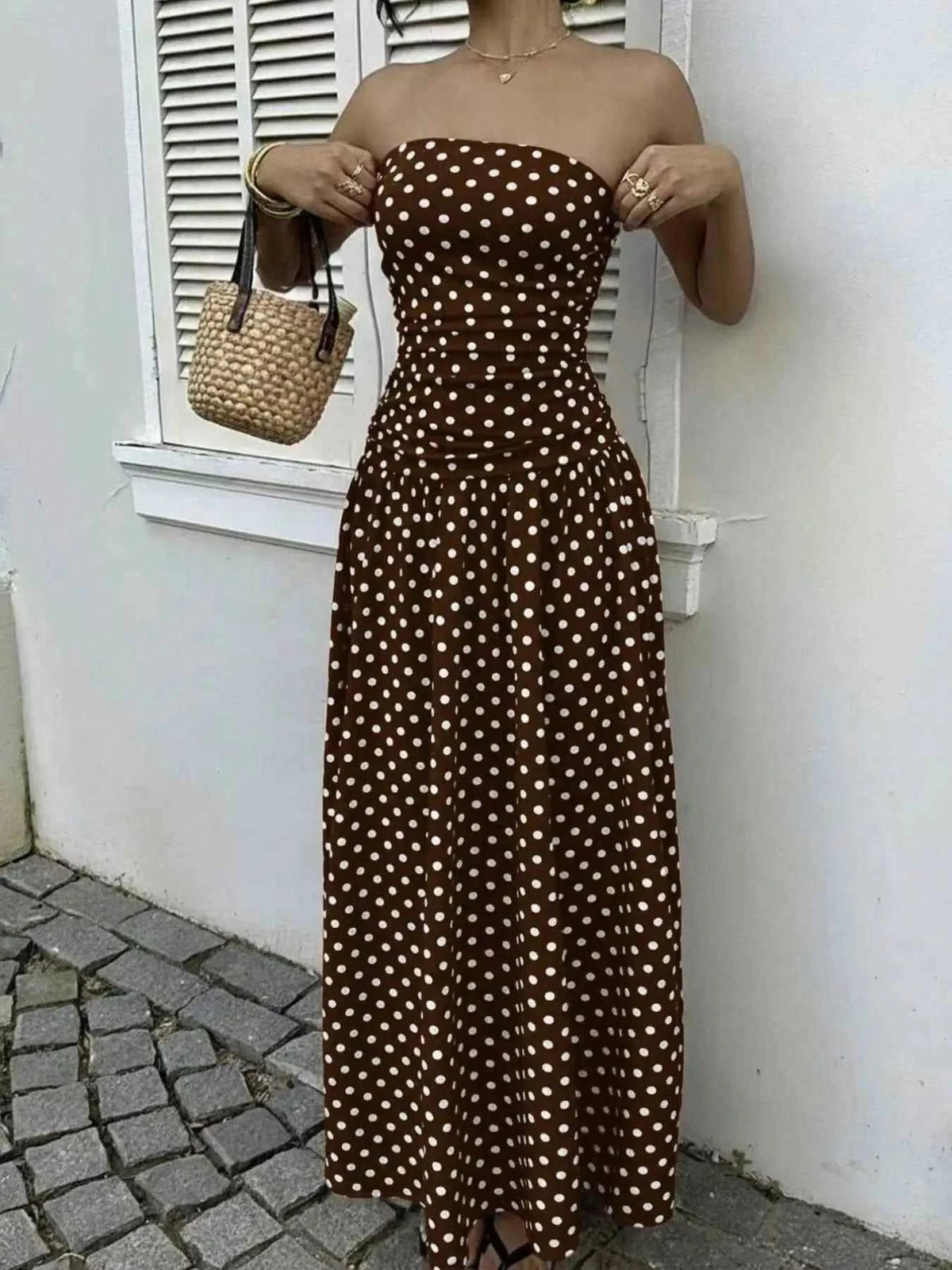 Polka Dot Strapless Maxi Dress in brown with white polka dots, fitted bodice, and flowing skirt