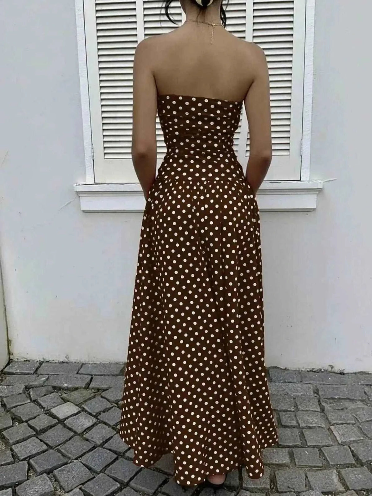 Polka Dot Strapless Maxi Dress in brown with white polka dots, fitted bodice and long flowing skirt from the back