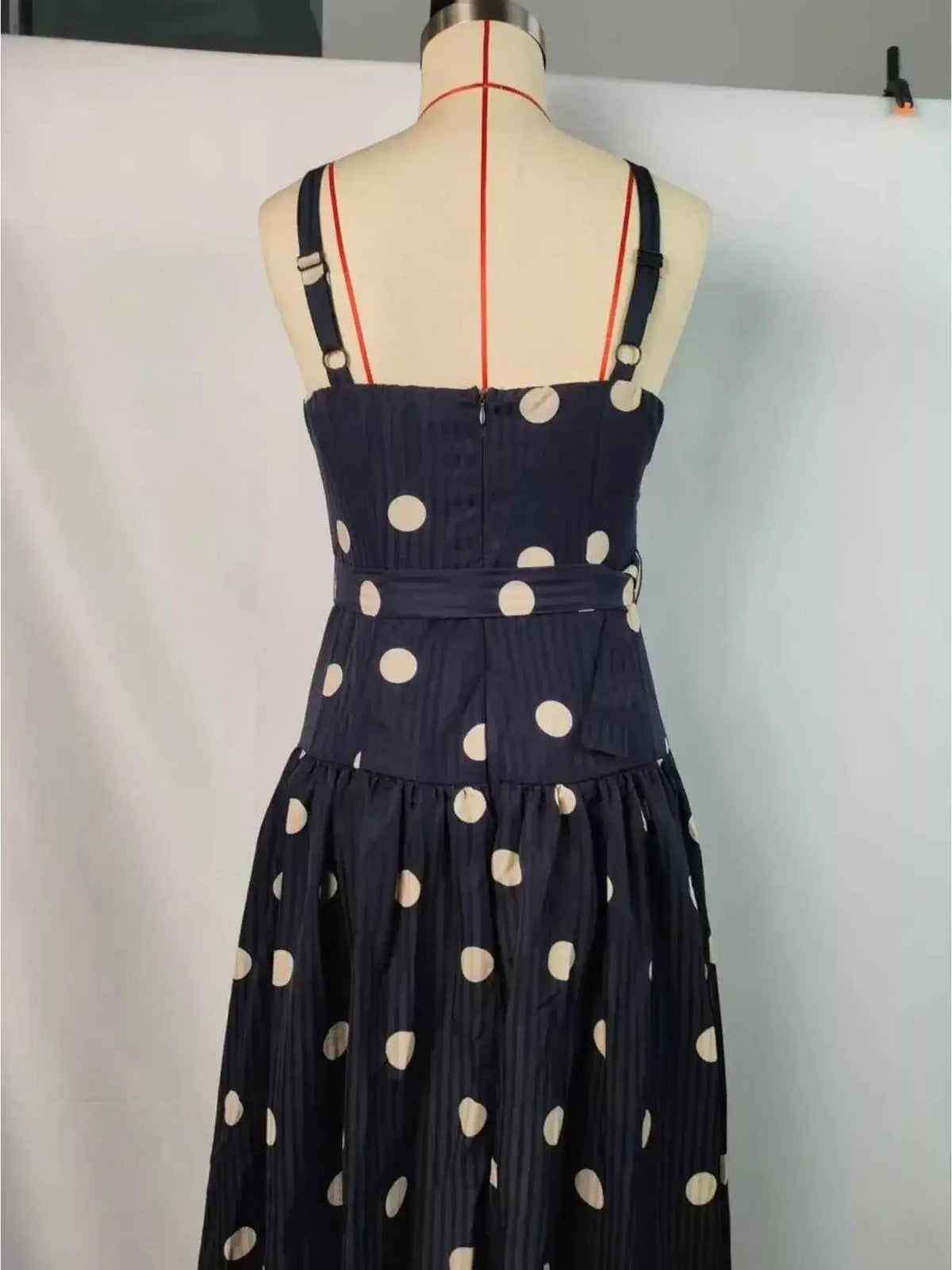 Polka Dot Sweetheart Neck Midi Dress in navy blue polyester with white polka dots, adjustable straps, and a belted waist detail