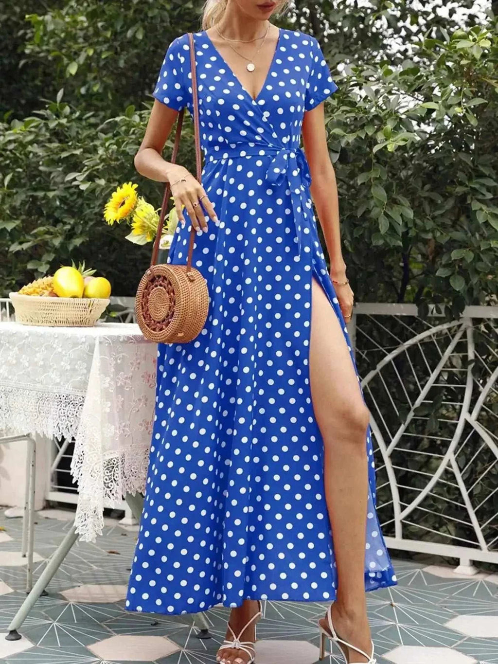 Polka Dot Wrap Maxi Dress in bright blue with white polka dots, short sleeves, belted waist, and a high slit on one side