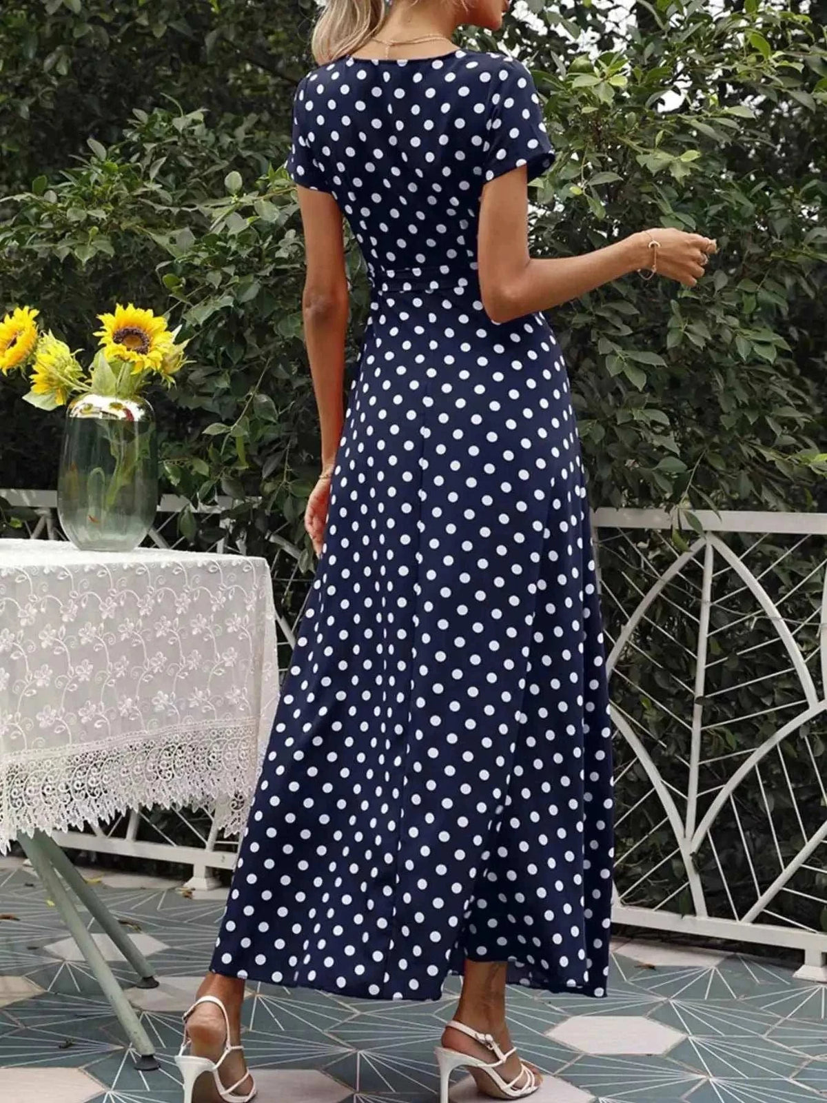 Polka Dot Wrap Maxi Dress in navy blue with white polka dots, short sleeves, belted waist, and flowing maxi length