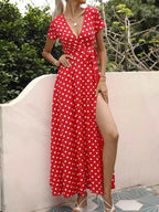 Polka Dot Wrap Maxi Dress in red polyester with white polka dots, belted waist, short sleeves, and a side slit