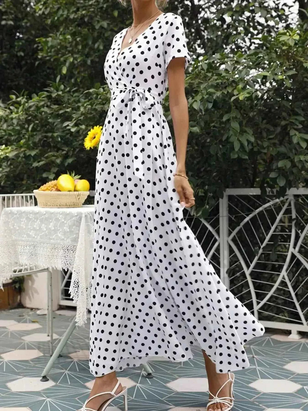 Polka Dot Wrap Maxi Dress in white polyester fabric with black polka dots, short sleeves, V-neck, and belted waist