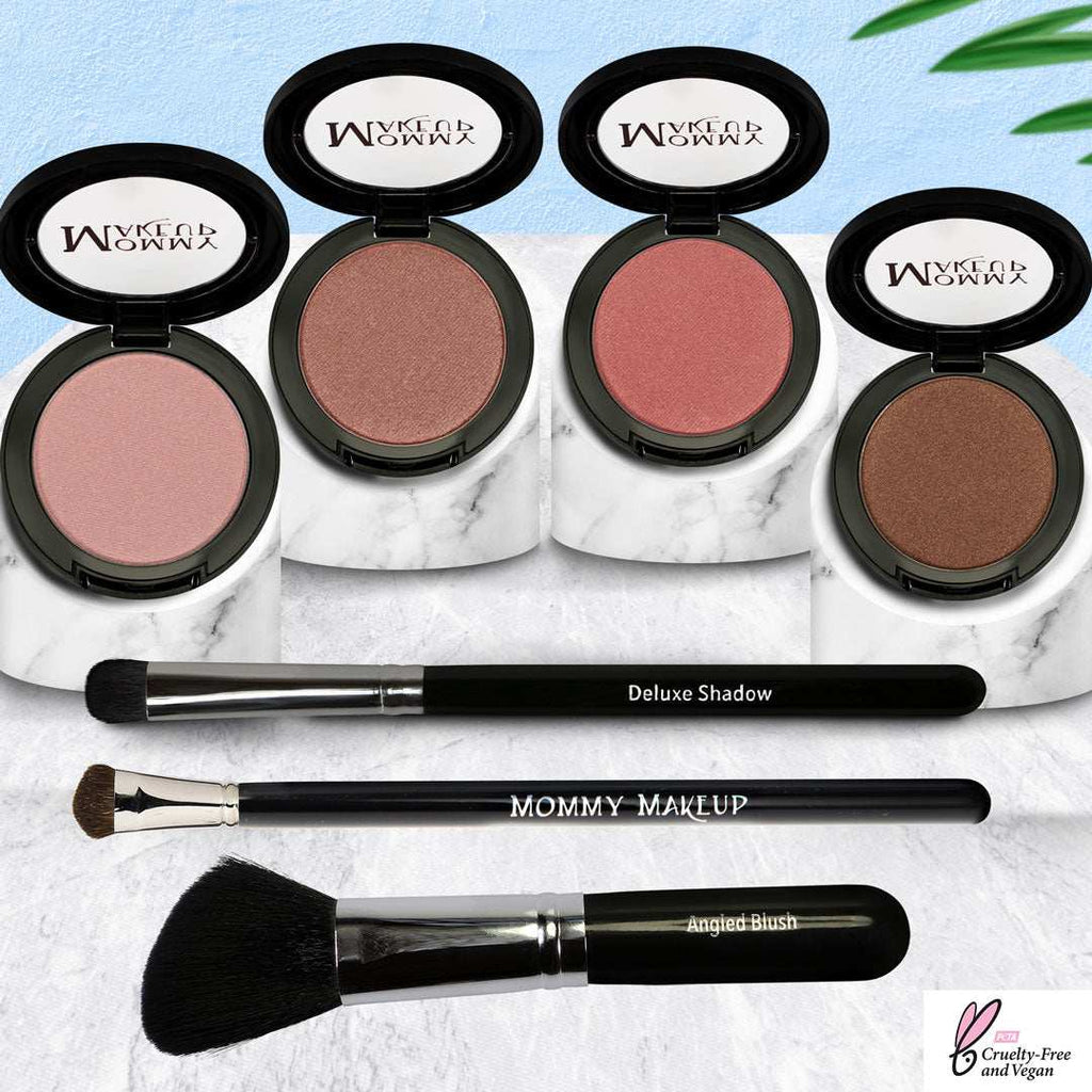 Pretty Perfect Set featuring four pressed powders in neutral pink, bronze, and peach tones with three black makeup brushes on marble trays