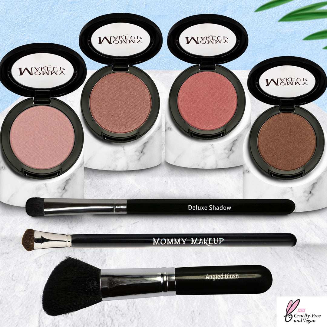 Pretty Perfect Set featuring four pressed powders in neutral pink, bronze, and peach tones with three black makeup brushes on marble trays