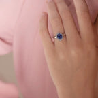 Princess Diana inspired 14K white gold ring with a deep blue oval sapphire center stone and a sparkling diamond halo
