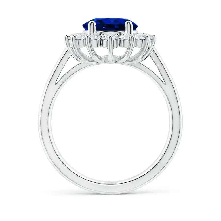 Princess Diana inspired 14K white gold ring featuring a deep blue oval lab-grown sapphire center with a round diamond halo setting