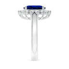 Princess Diana inspired 14K white gold ring featuring a deep blue oval lab-grown sapphire center with a sparkling diamond halo