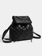 Mini black PU leather Quilted Chain Flap Backpack with diamond quilted pattern and silver chain detail on flap.