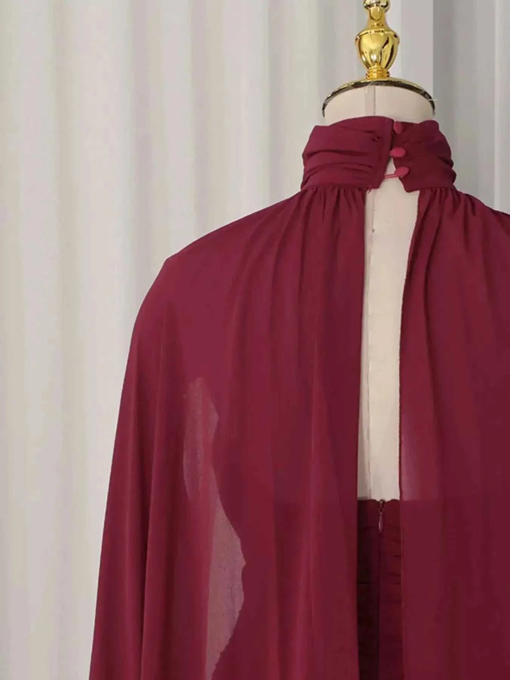 Ruched Halter Neck cape maxi dress in deep burgundy polyester featuring sheer fabric and button details at the neck