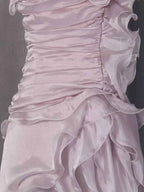 Ruffled High-Low Strapless Dress in light pink satin with cascading ruffles, ruched bodice, and a high-low hem for elegant movement.
