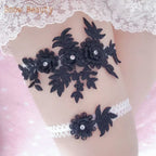 Black lace garter belt with floral applique and crystal details paired with white lace elastic band featuring a black flower applique,Sexy Lace Flower
