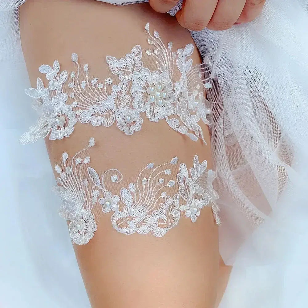 Sexy Lace Flower white lace bridal garter with floral embroidery and pearl accents on a woman's thigh