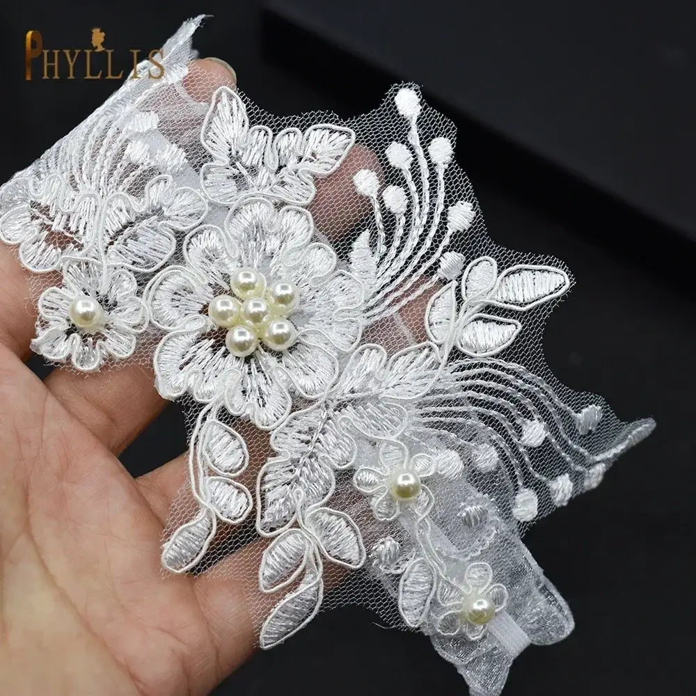 Wedding garter belt with white lace and floral embroidery featuring pearl and crystal accents, a Sexy Lace Flower design