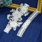Sexy Lace Flower white lace wedding garter belts with floral appliques, crystal and pearl embellishments on blue fabric