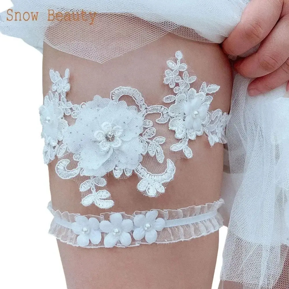 Sexy Lace Flower white lace wedding garter belt with floral appliques and pearls on bride's thigh