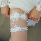 Sexy Lace Flower white lace wedding garters with floral appliques and crystal details on a woman's thigh