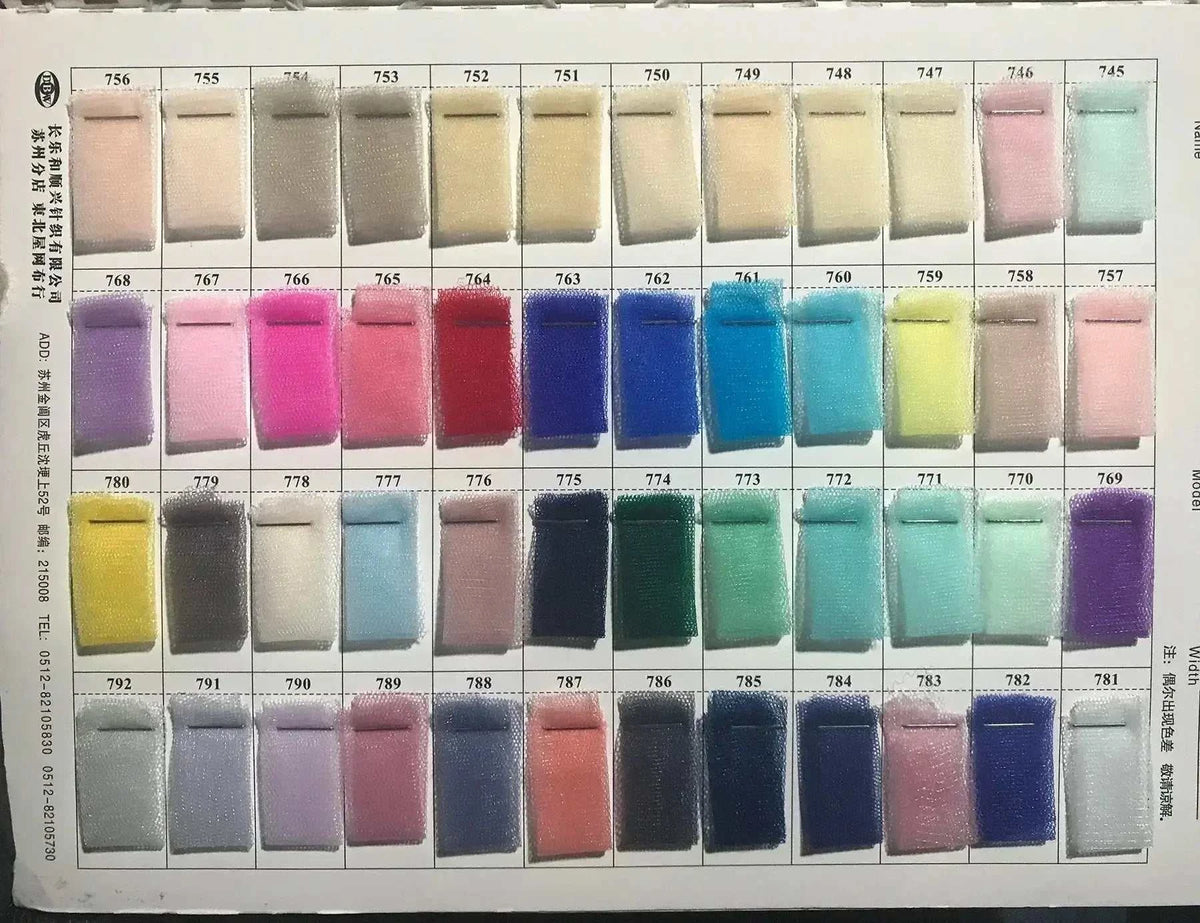 Assorted colorful fabric swatches arranged in a grid, featuring various pastel and vibrant shades on white card