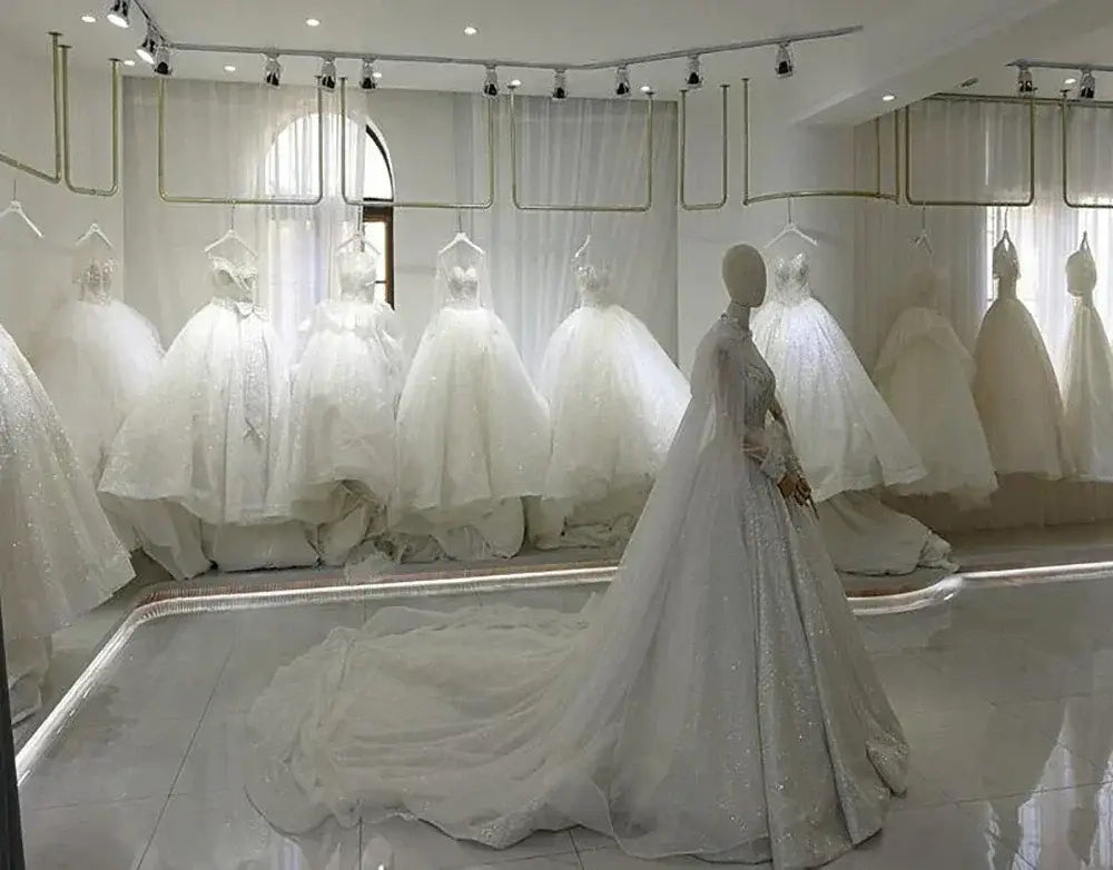 Short Wedding Dress collection featuring various white, voluminous ball gowns and a mannequin wearing a sparkling gown with a long train
