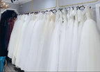Short Wedding Dress collection of white sleeveless bridal gowns with lace and tulle fabric on hangers