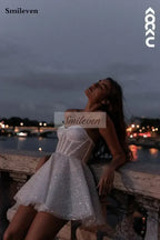 Short Wedding Dress in white tulle with A-line silhouette and sweetheart neckline, featuring shiny glitter detail and sleeveless design