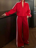 Red two-piece set with Side Stripes Zip Up Top and matching wide-leg pants featuring white side stripes and a zipper