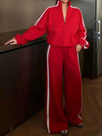 Red two-piece set with Side Stripes Zip Up Top and matching wide-leg pants featuring white side stripes and a zipper