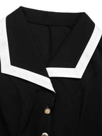 Sleeveless Button-Front Dress in black fabric with white trim collar and buttons down front, featuring a sleek modern style.