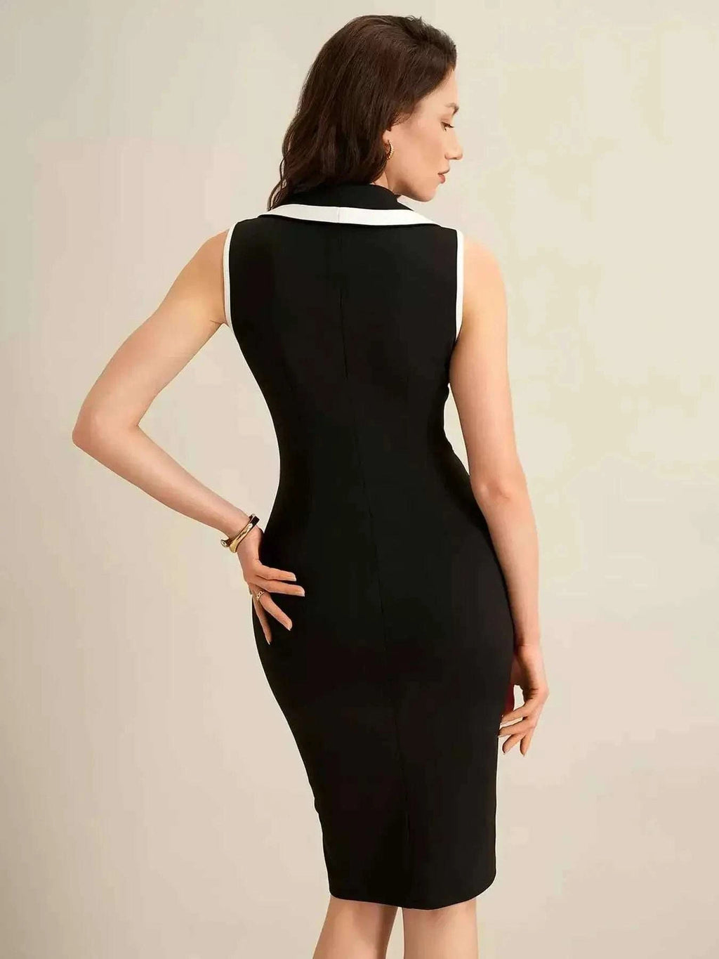 Sleeveless Button-Front Dress in black with white collar trim, sleeveless fitted silhouette, and knee-length cut.