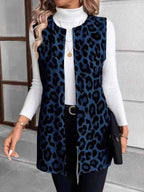 Sleeveless Leopard Print Vest in blue and black leopard pattern, knit material with pockets, worn over white turtleneck