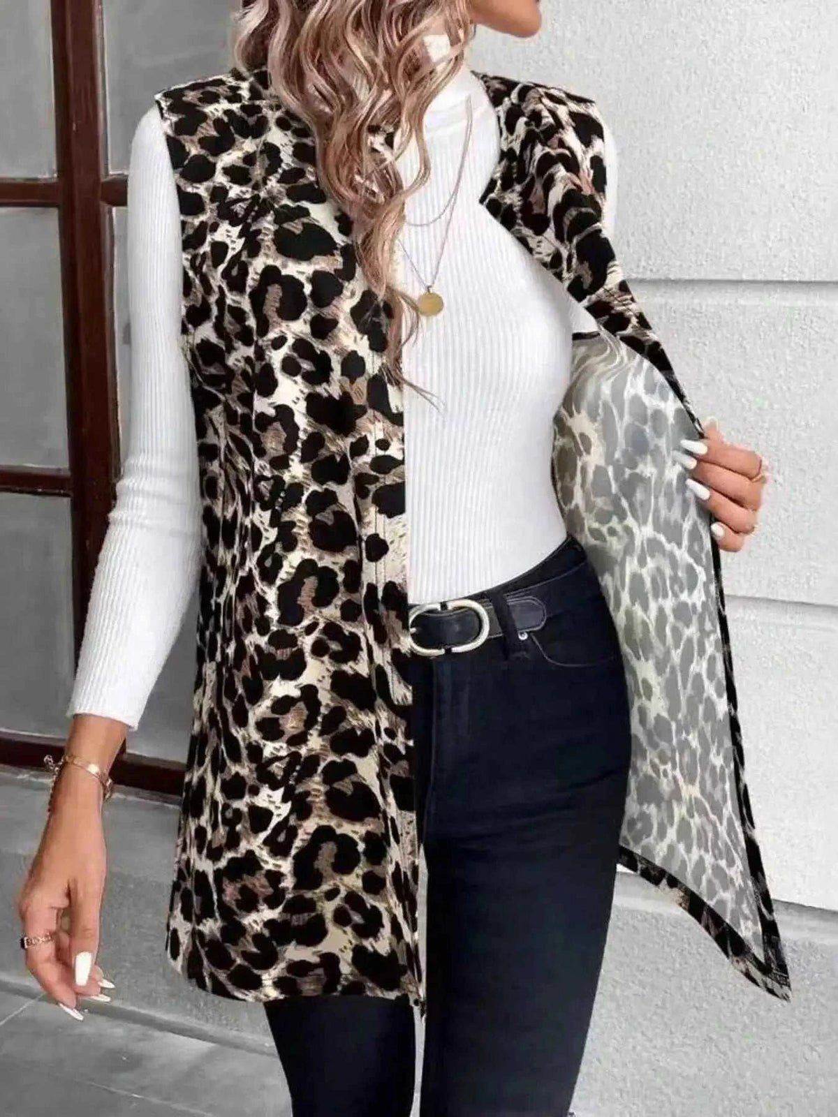 Sleeveless Leopard Print Vest in brown and black leopard pattern, pocketed with open front, worn over a white ribbed long sleeve top