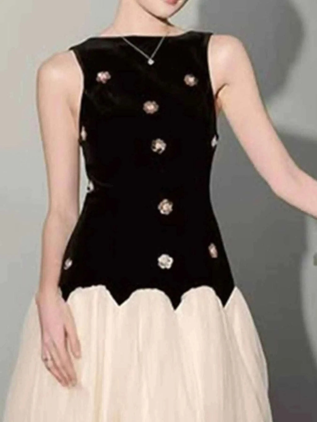 Sleeveless Tulle Maxi Dress featuring a sleeveless black velvet bodice with floral appliques and a flowing ivory tulle skirt