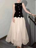 Sleeveless Tulle Maxi Dress featuring a black sleeveless velvet bodice with embellishments and a flowing white tulle skirt.