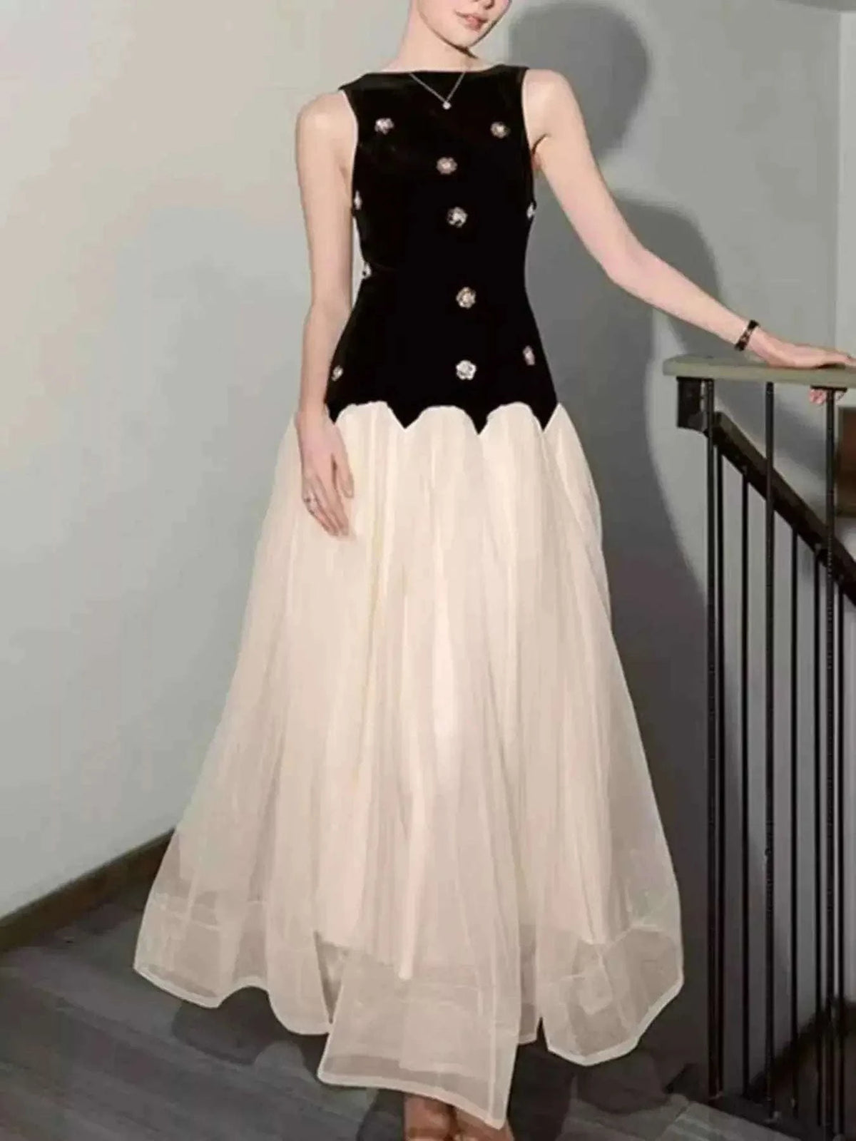 Sleeveless Tulle Maxi Dress featuring a black sleeveless velvet bodice with embellishments and a flowing white tulle skirt.