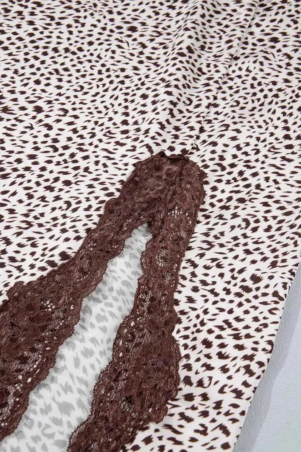 Slit Animal Print Skirt featuring brown lace detail and small irregular brown spots on white fabric with a front split